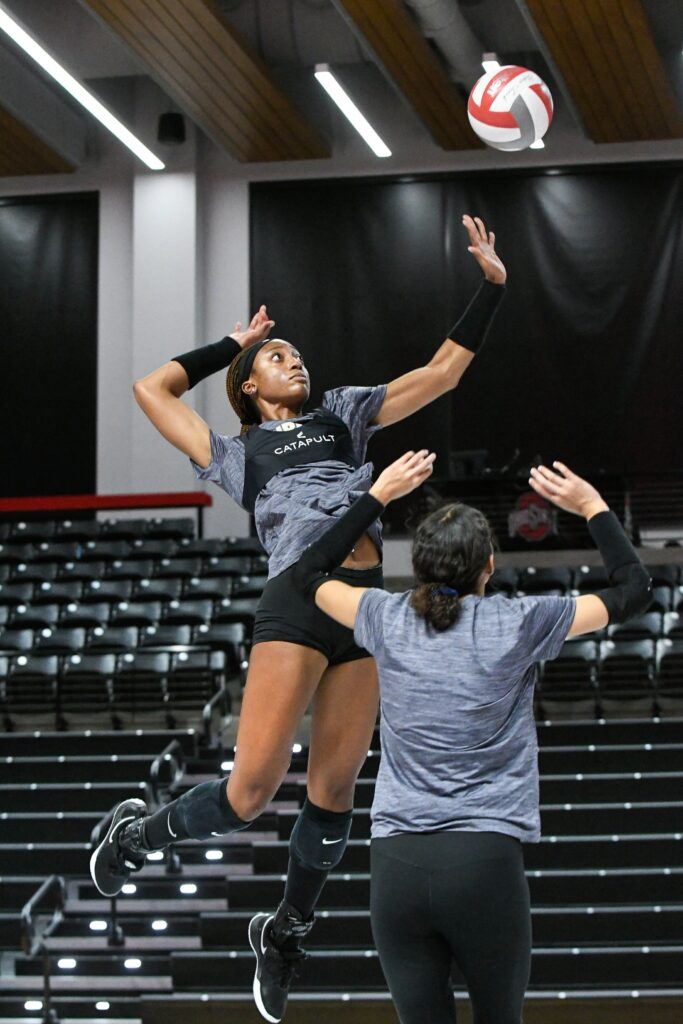 Purdue Volleyball player in mid-air attack during practice, wearing Catapult gear.